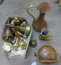 A collection of metalware including two hammered copper chargers, a small kettle, jugs, brass hand