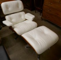 A Charles & Ray Eames style cream leather simulated rosewood revolving lounge chair and ottoman
