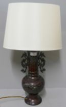 An oriental bronze table lamp