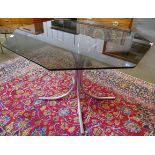 A chrome and hexagonal glass topped dining table