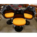 A set of three Eero Saarinen black laminate tulip chairs