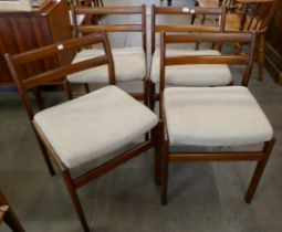 A set of four teak dining chairs