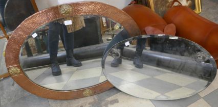 An oval copper framed mirror and one other