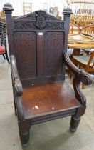 A Victorian Jacobean Revival carved oak Bishops chair