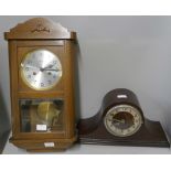 A German wooden cased wall clock and a mantel clock