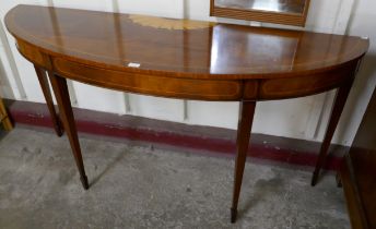 A Regency style inlaid mahogany demi lune console table