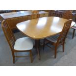 A Danish Gudme Mobelfabrik teak extending dining table and four teak dining chairs