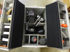 A Mamiya 645 1000s medium format film camera with three lenses; 210mm, 150mm, 80mm, a range of