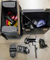 A Canon T50 35mm SLR camera, various remote triggers, flash gun, accessories, Polaroid camera,