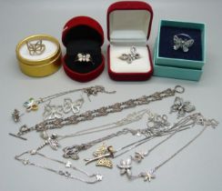 A collection of silver butterfly jewellery, including four boxed rings