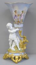 A hand painted porcelain vase with putti holding the vase with stag opposite with gold decoration,