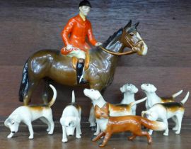 A Beswick huntsman on brown horse, model 1501, six hounds and fox