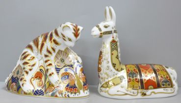 A Royal Crown Derby Bengal tiger cub paperweight, gold stopper and a llama, gold stopper