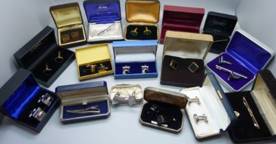 A collection of cufflinks and tie-pins, boxed