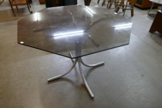 A chrome and hexagonal glass topped dining table