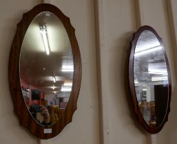 A pair of teak framed mirrors