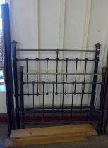 A Victorian cast steel and brass bed