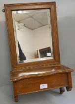 A wooden mirrored wall mount