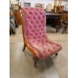 A Victorian walnut and fabric upholstered nursing chair