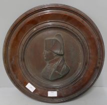 A copper plaque of Napoleon in a wooden frame