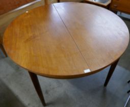 A Danish circular teak extending dining table