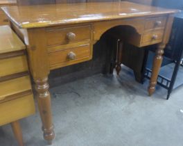 A Victorian style stained pine writing table