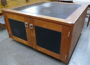 A teak and black vinyl Pandora's box coffee table