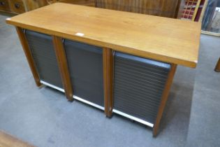 A teak tambour fronted office cabinet
