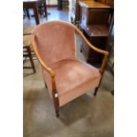 A 1930's beech and fabric upholstered fireside chair