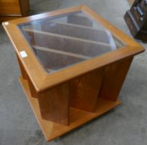 A teak and glass topped coffee table/magazine rack