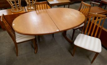 A G-Plan Fresco teak oval extending dining table and four chairs