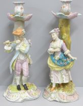 A pair of continental porcelain figural candlesticks, 40cm