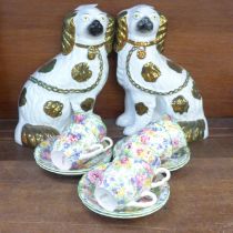 A pair of Staffordshire spaniels and Brama chintz cups and saucers, one cup chipped