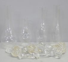 A collection of crystal and glass decanter stoppers and four glass oil lamp shades