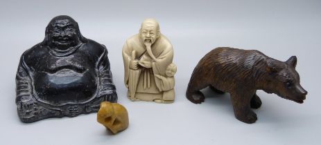 A carved Black Forest bear, a Buddha figure, a resin netsuke and a small carved figure