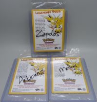 Three sealed vintage Pokemon cards, Moltres, Zapdos, Articuno