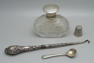 Silver items; salt spoon, thimble, silver topped scent bottle and a button hook, neck of glass scent