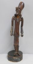 A carved wooden figural pipe and stand, a/f, one eye missing