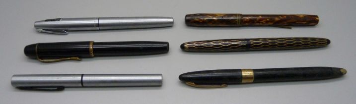 A Waterman Skywriter pen with 14ct gold nib, lacking clip, four Sheaffer pens and a Tropen Scholar