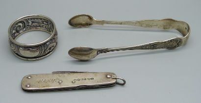 A silver napkin ring, a silver handled pocket knife and a pair of silver sugar bows, 37g without