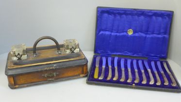 An Edwardian pen stand with double inkwell and a cased set of silver handled pistol grip knives, one