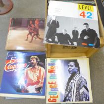A collection of LP records including Dire Straits, Soft Cell, Queen, Eric Clapton, The Police,