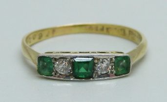 An 18ct gold and five stone Art Deco ring, set with two diamonds, two emeralds and a replacement
