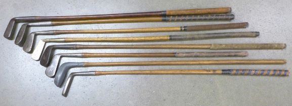 A collection of eight hickory golf clubs including an early example circa 1850s and onwards to