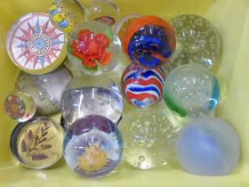 A collection of nineteen glass paperweights