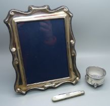 A silver photograph frame, 14cm x 18cm, a silver ring box and a silver and mother of pearl penknife