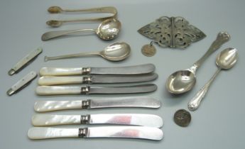Four silver spoons, a pair of silver sugar bows, two silver and mother of pearl fruit knives, a