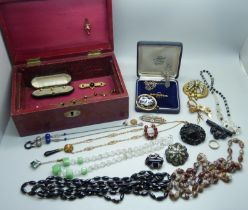 A leather covered jewellery box containing Victorian and later costume jewellery