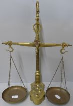 A brass balance scale and weights