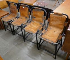 A set of four Les Arc style black metal and tan leather chairs, after Charlotte Perriand